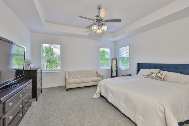 6215 Voyagers Pl, Apollo Beach, FL 33572 - bedroom featuring a raised ceiling, light carpet, multiple windows, and ceiling fan