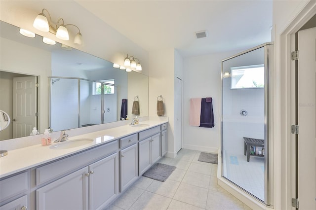 6215 Voyagers Pl, Apollo Beach, FL 33572 - bathroom featuring a stall shower, double vanity, and tile patterned flooring