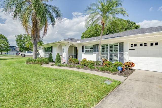 1954 Arvis Cir W, Clearwater, FL 33764 - ranch-style home with stucco siding, a front lawn, an attached garage, and concrete driveway