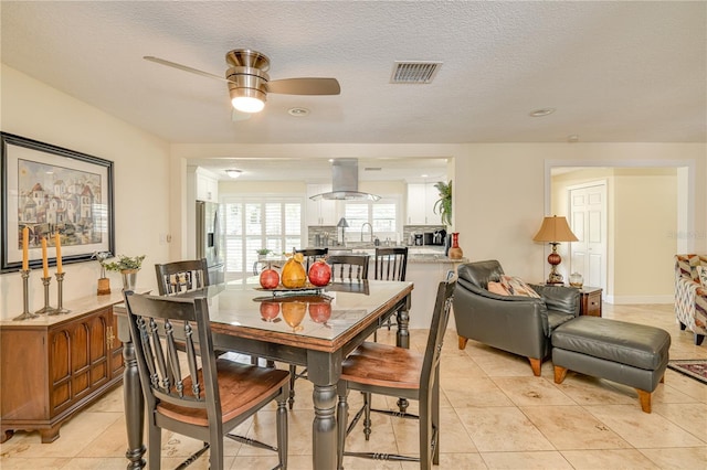 1954 Arvis Cir W, Clearwater, FL 33764 - dining room featuring a ceiling fan, light tile patterned floors, and a textured ceiling