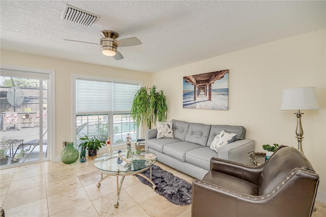 1954 Arvis Cir W, Clearwater, FL 33764 - living room with a ceiling fan, a textured ceiling, and tile patterned floors
