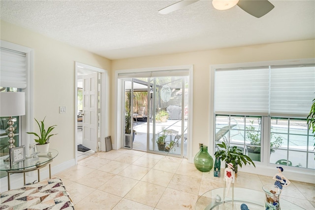 1954 Arvis Cir W, Clearwater, FL 33764 - entrance foyer featuring ceiling fan, a sunroom, light tile patterned flooring, and a textured ceiling