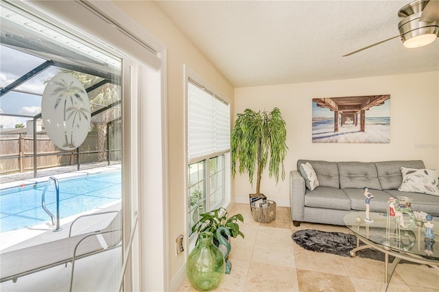 1954 Arvis Cir W, Clearwater, FL 33764 - tiled living room with plenty of natural light, a ceiling fan, and a textured ceiling
