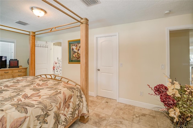 1954 Arvis Cir W, Clearwater, FL 33764 - bedroom with a textured ceiling and light tile patterned flooring