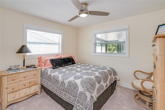 1954 Arvis Cir W, Clearwater, FL 33764 - bedroom with light carpet, a ceiling fan, and a textured ceiling
