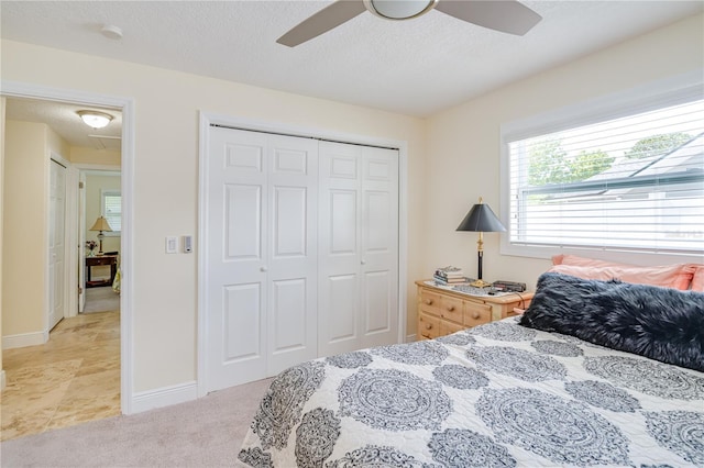 1954 Arvis Cir W, Clearwater, FL 33764 - bedroom featuring a closet, a textured ceiling, and a ceiling fan