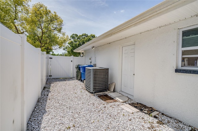 1954 Arvis Cir W, Clearwater, FL 33764 - view of property exterior with a gate and stucco siding