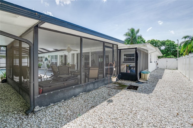 1954 Arvis Cir W, Clearwater, FL 33764 - rear view of house featuring a sunroom, a gate, ceiling fan, and a patio