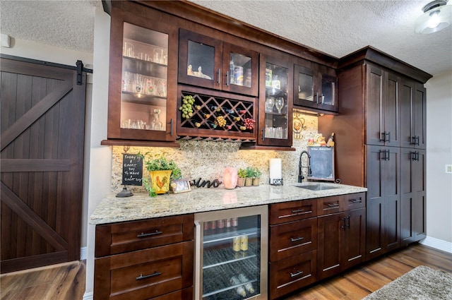 3539 Lake Padgett Dr, Land O Lakes, FL 34639 - indoor bar with beverage cooler, a textured ceiling, wood finished floors, and decorative backsplash