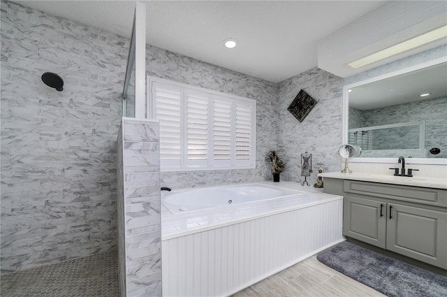 3539 Lake Padgett Dr, Land O Lakes, FL 34639 - bathroom featuring a whirlpool tub, walk in shower, and vanity