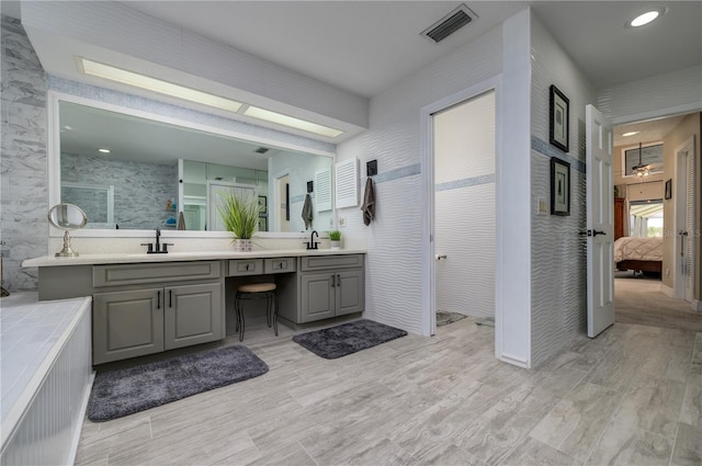 3539 Lake Padgett Dr, Land O Lakes, FL 34639 - ensuite bathroom with double vanity, wood finished floors, and a shower