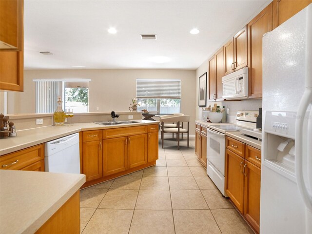 11212 Laurel Brook Ct, Riverview, FL 33569 - kitchen featuring white appliances, healthy amount of natural light, light countertops, light tile patterned floors, and recessed lighting