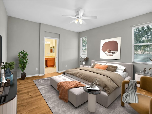 11212 Laurel Brook Ct, Riverview, FL 33569 - bedroom featuring light wood-style floors, ensuite bathroom, and a ceiling fan