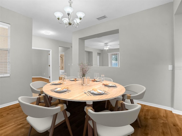 11212 Laurel Brook Ct, Riverview, FL 33569 - dining room featuring a chandelier, wood finished floors, and a ceiling fan