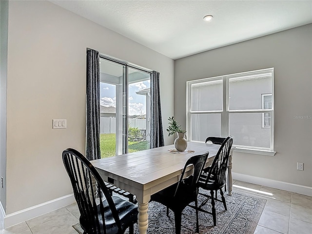 35428 Crescent Creek Dr, Zephyrhills, FL 33541 - dining space with baseboards and light tile patterned floors
