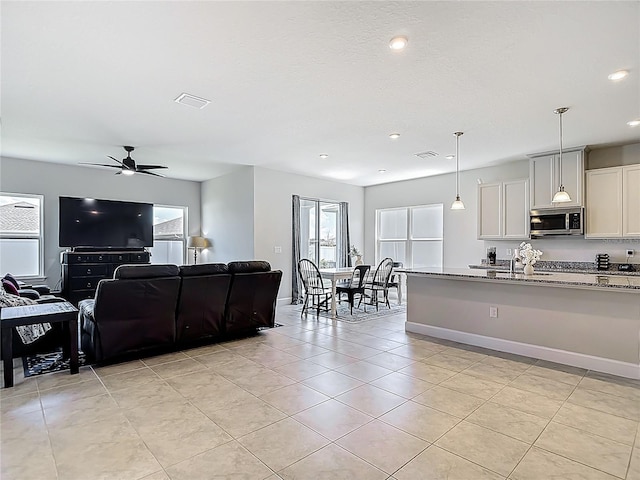 35428 Crescent Creek Dr, Zephyrhills, FL 33541 - living area with light tile patterned floors, recessed lighting, and ceiling fan