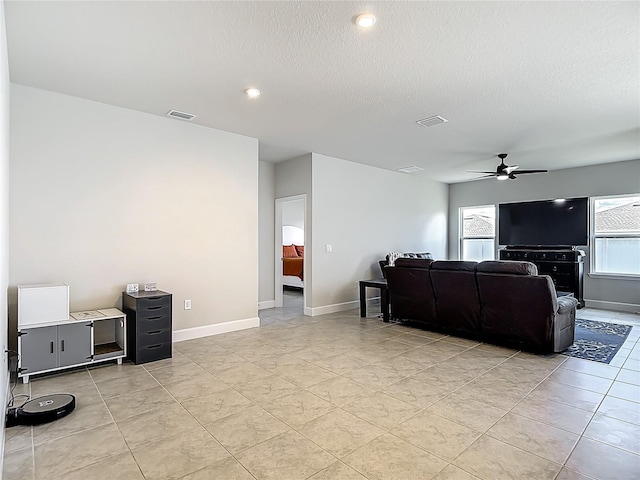 35428 Crescent Creek Dr, Zephyrhills, FL 33541 - living area featuring ceiling fan, a textured ceiling, and recessed lighting