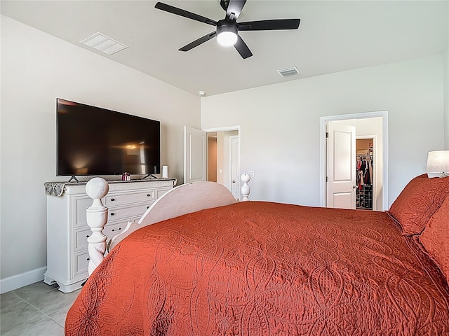 35428 Crescent Creek Dr, Zephyrhills, FL 33541 - bedroom featuring a walk in closet, ceiling fan, and light tile patterned floors