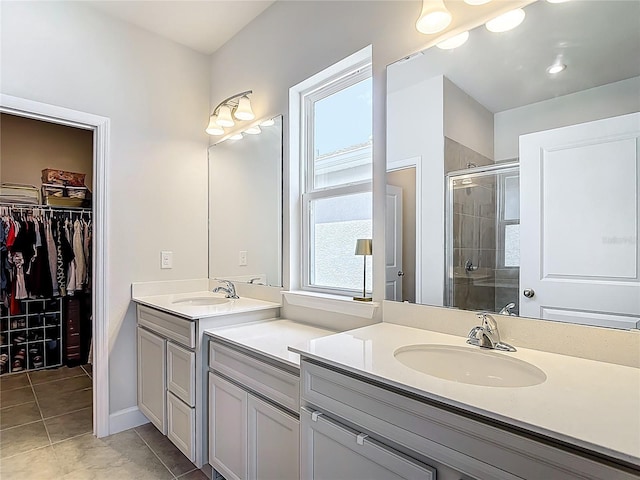 35428 Crescent Creek Dr, Zephyrhills, FL 33541 - bathroom with vanity, a shower stall, tile patterned flooring, and a spacious closet
