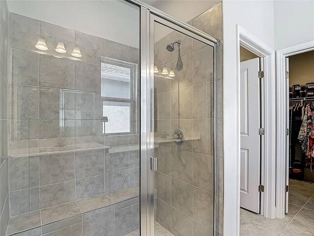 35428 Crescent Creek Dr, Zephyrhills, FL 33541 - bathroom with a shower stall, a spacious closet, and tile patterned flooring