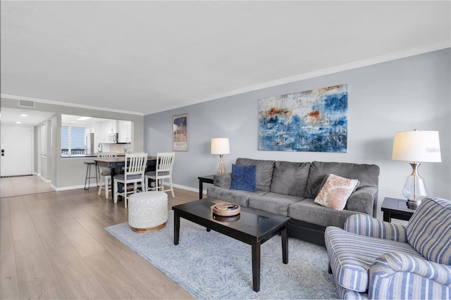 9495 Blind Pass Rd Unit 1103, St Pete Beach, FL 33706 - living room featuring light wood-style floors and crown molding