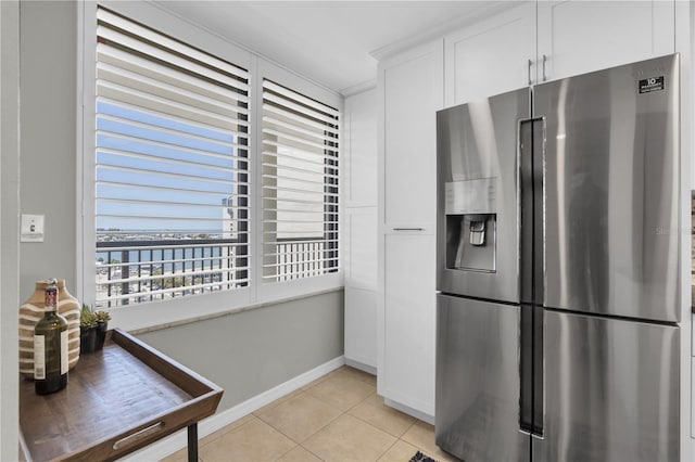 9495 Blind Pass Rd Unit 1103, St Pete Beach, FL 33706 - kitchen featuring stainless steel fridge with ice dispenser, light tile patterned flooring, white cabinetry, and a water view