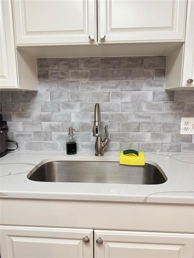 1550 S Belcher Rd Unit 335, Clearwater, FL 33764 - kitchen view of light countertops, decorative backsplash, and white cabinets