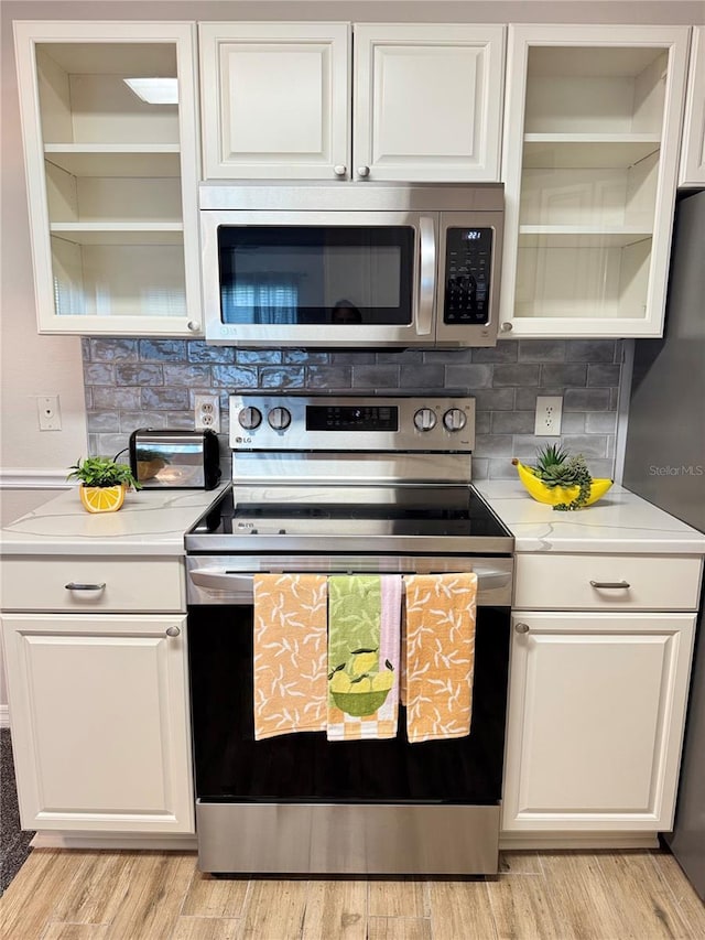 1550 S Belcher Rd Unit 335, Clearwater, FL 33764 - kitchen with appliances with stainless steel finishes, light countertops, and white cabinets