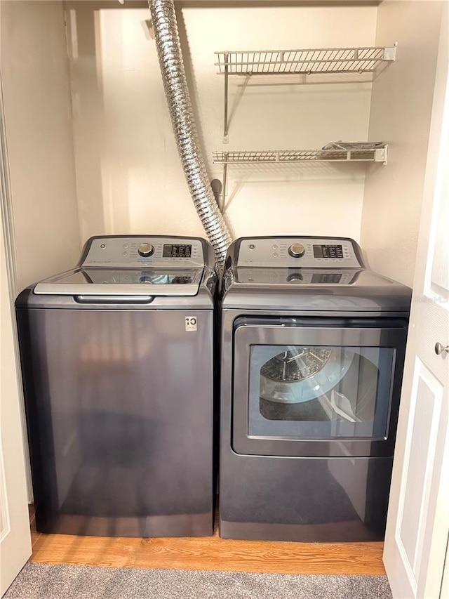 1550 S Belcher Rd Unit 335, Clearwater, FL 33764 - laundry room with washer and dryer and light wood-style floors