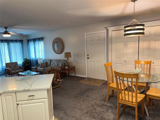 1550 S Belcher Rd Unit 335, Clearwater, FL 33764 - dining room with dark carpet, ceiling fan, and a textured ceiling