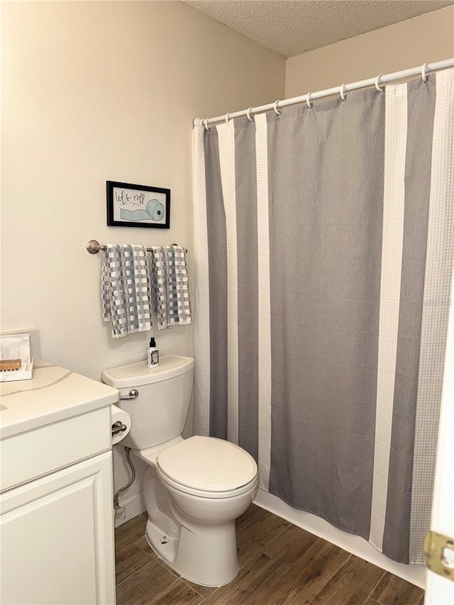 1550 S Belcher Rd Unit 335, Clearwater, FL 33764 - bathroom with wood finished floors, vanity, a textured ceiling, and a shower with curtain