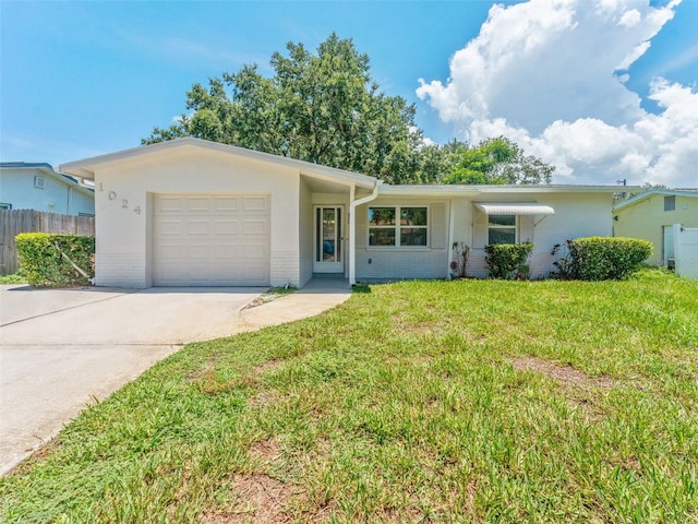 1024 San Marco Dr, Largo, FL 33770 - ranch-style home with an attached garage, driveway, brick siding, and stucco siding