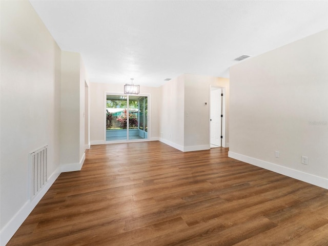 1024 San Marco Dr, Largo, FL 33770 - empty room featuring a chandelier and wood finished floors