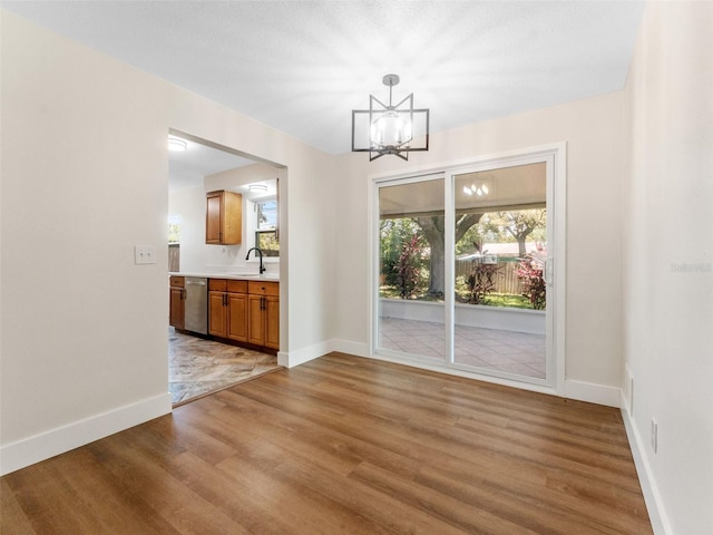 1024 San Marco Dr, Largo, FL 33770 - unfurnished dining area with light wood-type flooring and a chandelier
