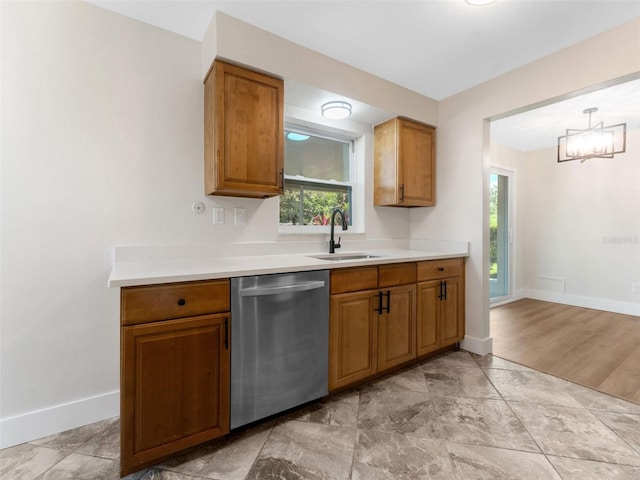 1024 San Marco Dr, Largo, FL 33770 - kitchen with stainless steel dishwasher, brown cabinets, light countertops, and a chandelier