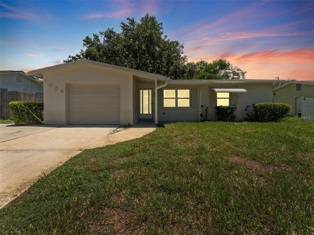 1024 San Marco Dr, Largo, FL 33770 - view of front of house featuring a garage, concrete driveway, and stucco siding