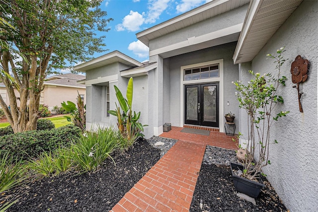 3509 Williston Loop, Land O Lakes, FL 34639 - view of exterior entry with stucco siding and french doors