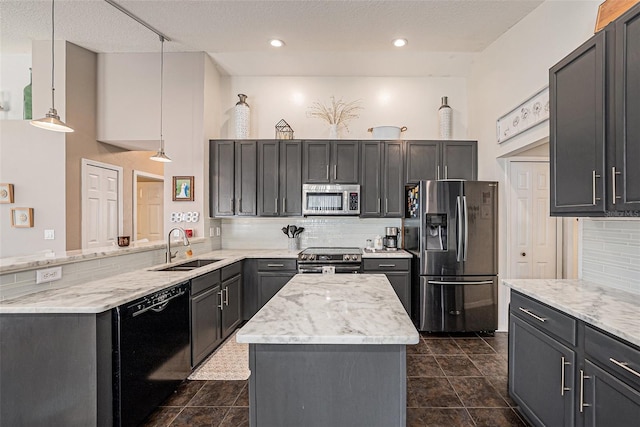 3509 Williston Loop, Land O Lakes, FL 34639 - kitchen featuring stainless steel appliances, a peninsula, backsplash, and light stone counters