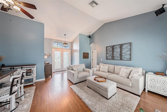 3509 Williston Loop, Land O Lakes, FL 34639 - living area with ceiling fan, arched walkways, french doors, wood finished floors, and high vaulted ceiling