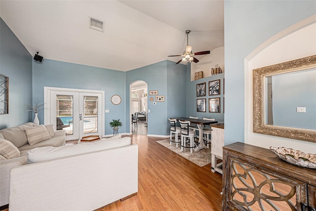 3509 Williston Loop, Land O Lakes, FL 34639 - living area featuring arched walkways, ceiling fan, wood finished floors, french doors, and vaulted ceiling