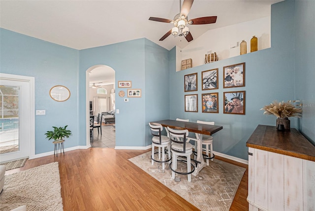 3509 Williston Loop, Land O Lakes, FL 34639 - dining area featuring a ceiling fan, arched walkways, wood finished floors, plenty of natural light, and vaulted ceiling