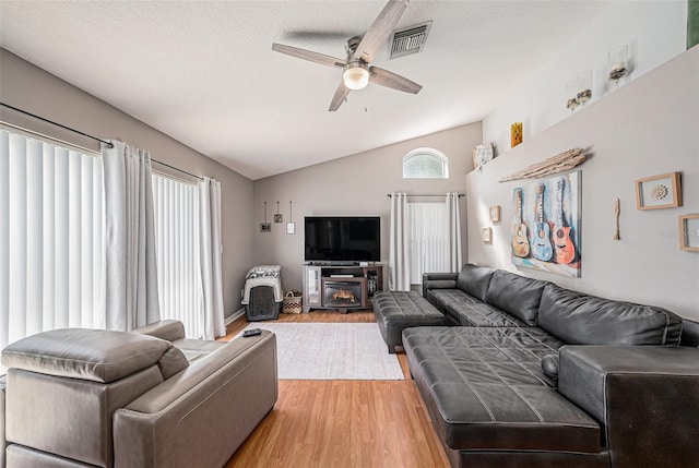 3509 Williston Loop, Land O Lakes, FL 34639 - living area with ceiling fan, lofted ceiling, light wood finished floors, and a textured ceiling