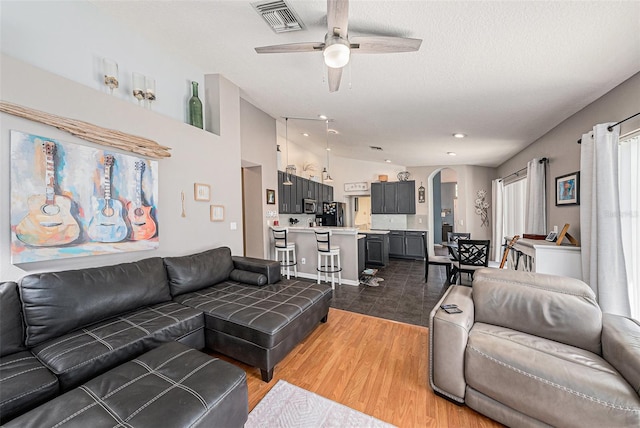 3509 Williston Loop, Land O Lakes, FL 34639 - living area featuring arched walkways, a ceiling fan, and wood finished floors