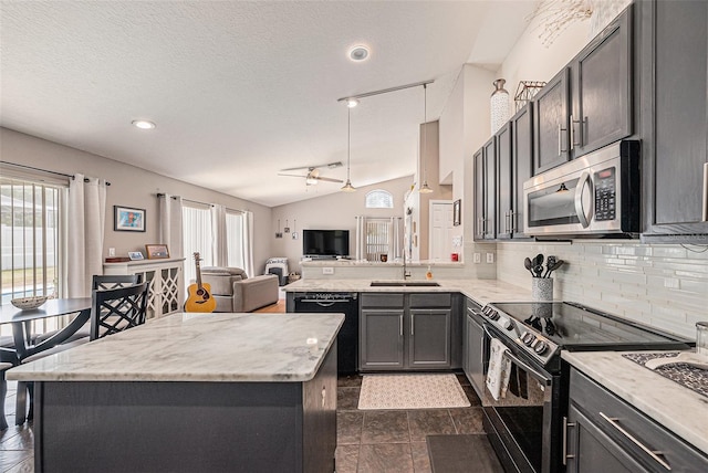 3509 Williston Loop, Land O Lakes, FL 34639 - kitchen with black appliances, open floor plan, ceiling fan, decorative backsplash, and a kitchen island