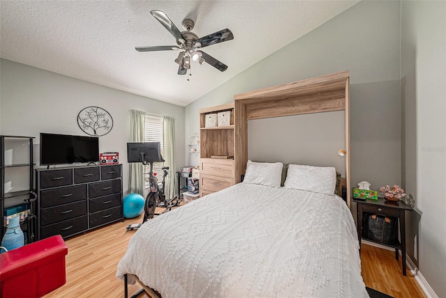 3509 Williston Loop, Land O Lakes, FL 34639 - bedroom with lofted ceiling, wood finished floors, a textured ceiling, and ceiling fan