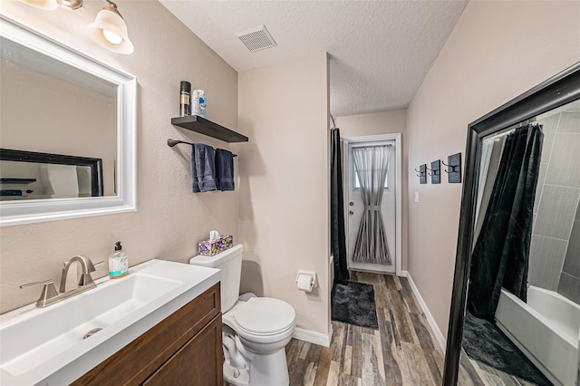 3509 Williston Loop, Land O Lakes, FL 34639 - full bath with wood finished floors, vanity, a textured ceiling, and shower / bath combination with curtain