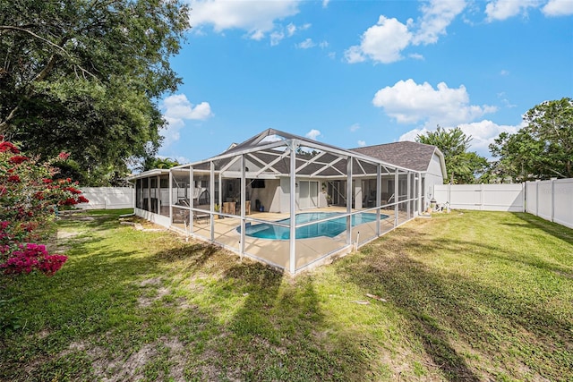 3509 Williston Loop, Land O Lakes, FL 34639 - rear view of house with a fenced backyard, glass enclosure, and a patio