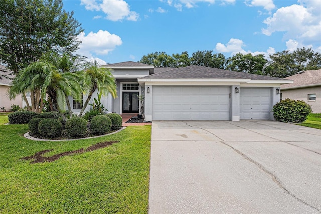 3509 Williston Loop, Land O Lakes, FL 34639 - ranch-style home featuring stucco siding, a front lawn, concrete driveway, a garage, and french doors