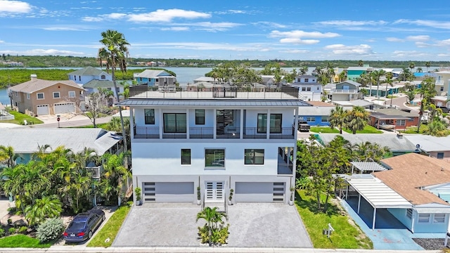 18077 3rd St E, Redington Shores, FL 33708 - view of front facade featuring a balcony, stucco siding, a residential view, and an attached garage
