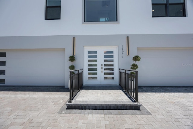 18077 3rd St E, Redington Shores, FL 33708 - view of front of property with stucco siding and a garage